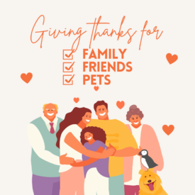 A cartoon family of two grandparents, two parents, a child, a dog, and a Puffin pile in for a big hug. The text reads "giving thanks for family, friends, and pets"